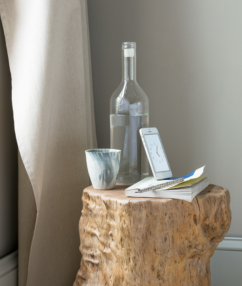 tree trunk bedside table with smartphone